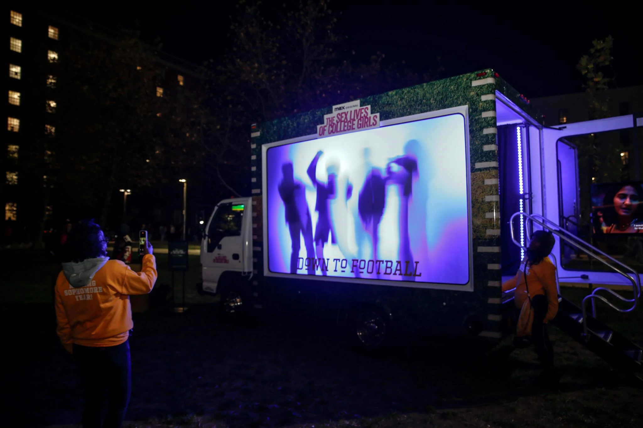 HBO campus scoreboard with an illuminated silhouette photo booth